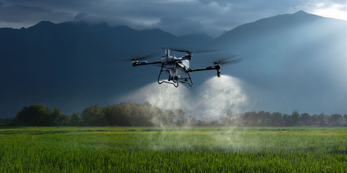 Drone agrícola pulverizando uma lavoura em um vale